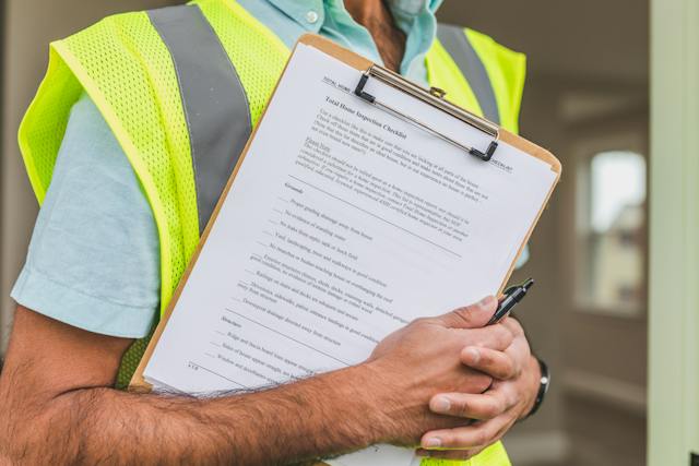 home inspection specialist holding a checklist